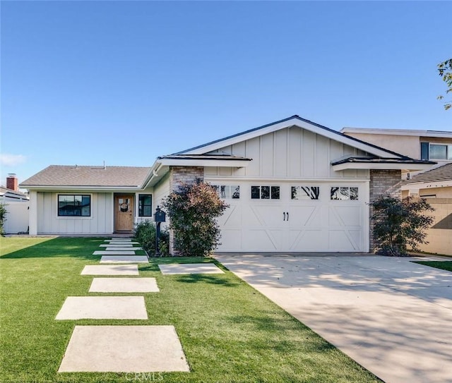 view of front facade with a front yard and a garage