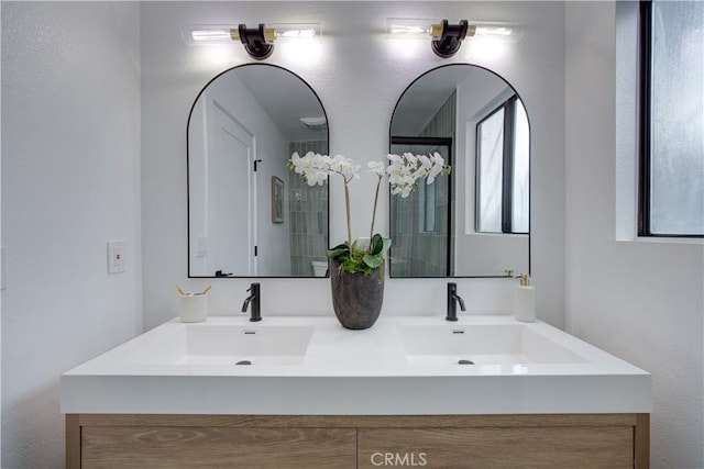 full bath featuring double vanity and a sink