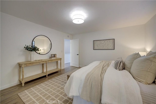 bedroom with hardwood / wood-style flooring