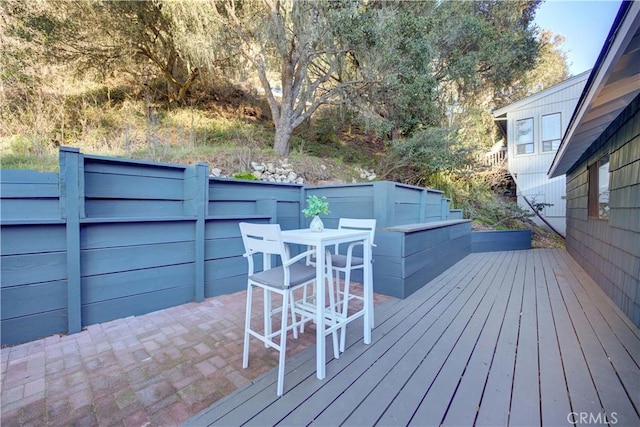 wooden terrace with outdoor dining area