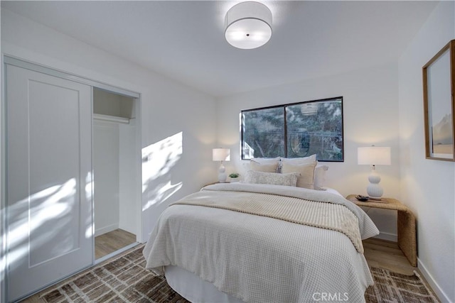 bedroom featuring wood-type flooring and a closet