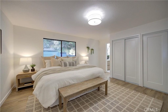 bedroom featuring light wood-style floors and baseboards