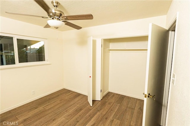 unfurnished bedroom featuring hardwood / wood-style flooring, a closet, and ceiling fan