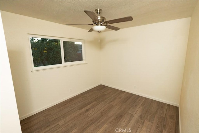 spare room with a textured ceiling, dark hardwood / wood-style floors, and ceiling fan