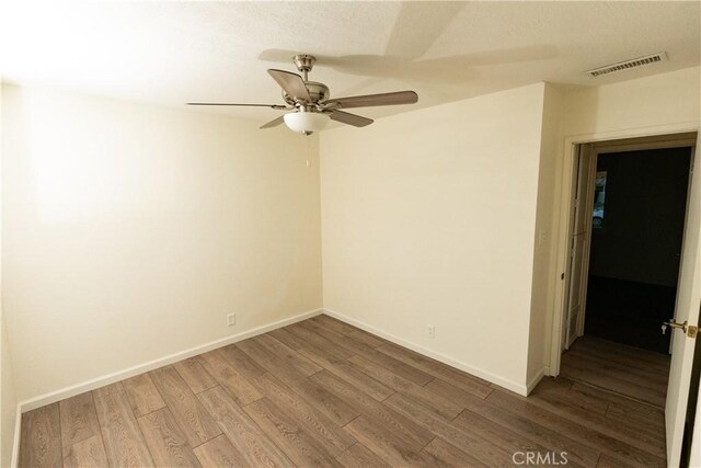 spare room featuring hardwood / wood-style flooring and ceiling fan