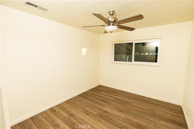 empty room featuring hardwood / wood-style flooring and ceiling fan