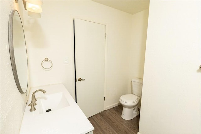 bathroom featuring vanity, toilet, and hardwood / wood-style floors