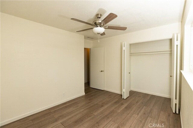 unfurnished bedroom with hardwood / wood-style floors, ceiling fan, and a closet