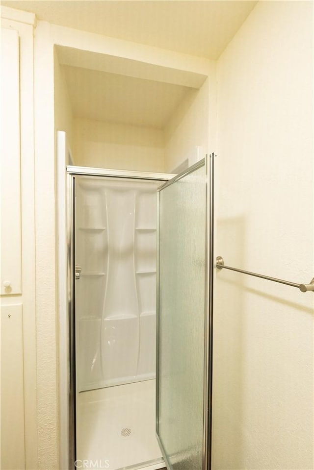 bathroom with a shower with shower door