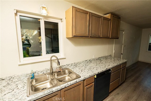 kitchen featuring light stone countertops, black dishwasher, sink, and dark hardwood / wood-style floors