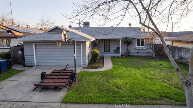 ranch-style house featuring a garage and a front lawn