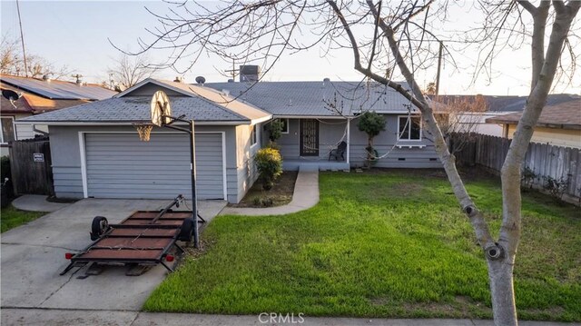 ranch-style home with a garage and a front lawn