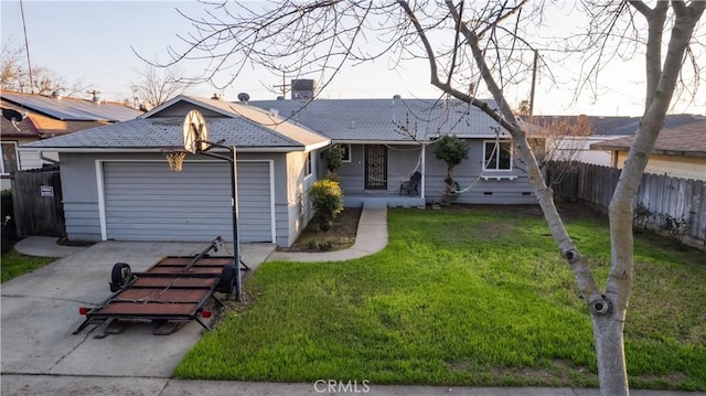 ranch-style home featuring a garage and a front lawn