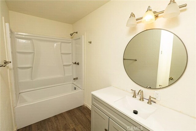 bathroom with vanity, wood-type flooring, and shower / bath combination