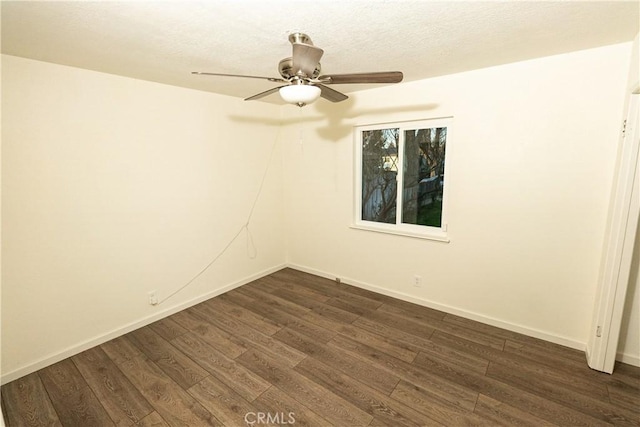 empty room featuring dark hardwood / wood-style flooring and ceiling fan