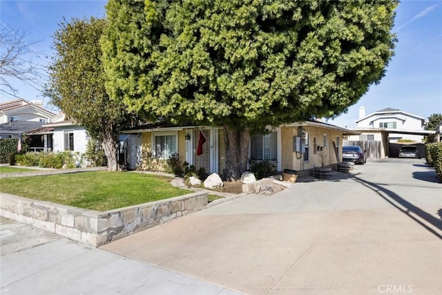 view of property hidden behind natural elements with a front lawn