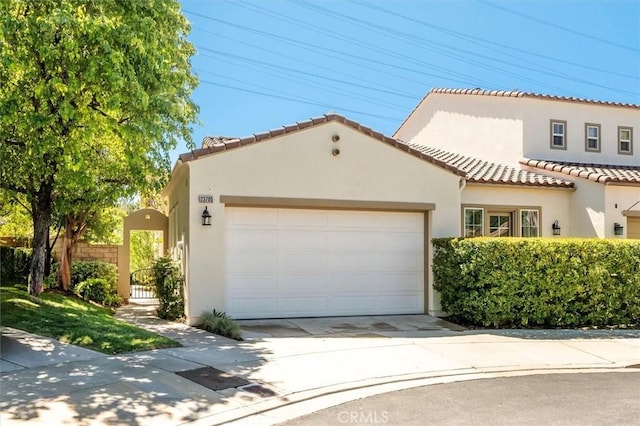 mediterranean / spanish house with a garage