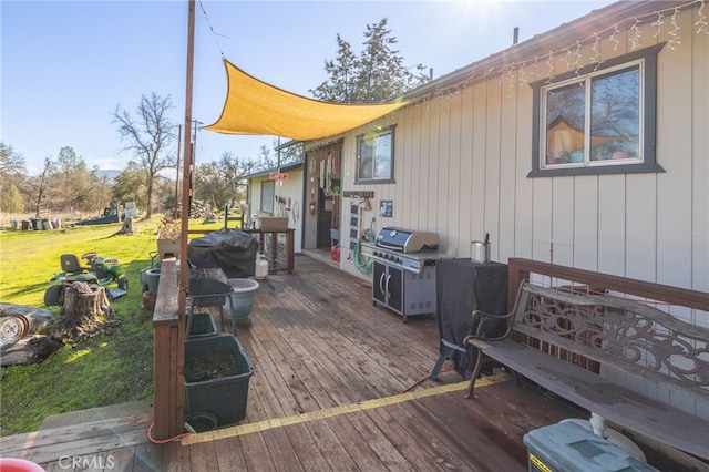 deck featuring a yard and grilling area