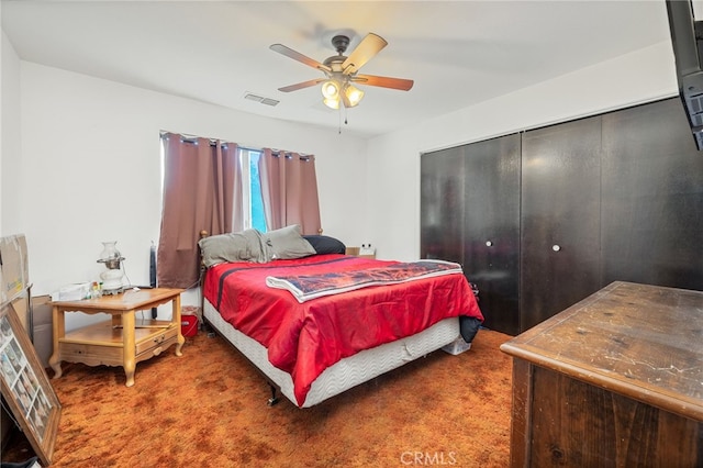 bedroom with ceiling fan, a closet, and carpet floors