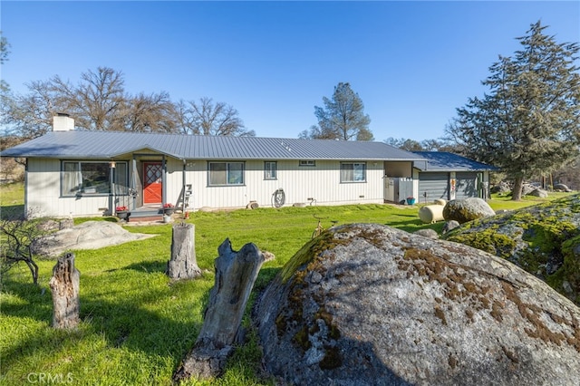 view of front of property with a garage and a front lawn