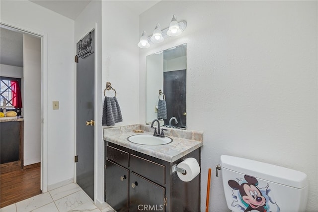 bathroom featuring toilet and vanity