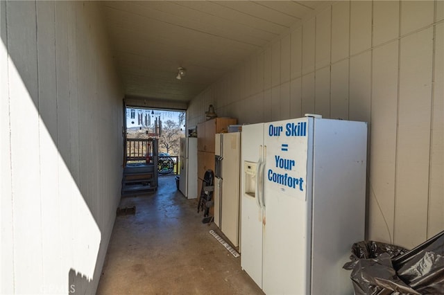 hall with concrete flooring