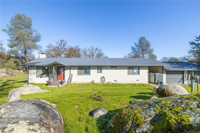 ranch-style house featuring a front yard and a garage