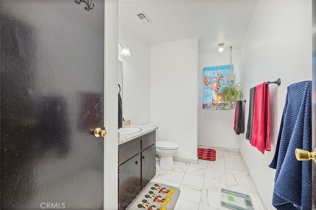 bathroom with toilet and vanity