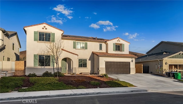 mediterranean / spanish home featuring a garage