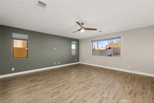 unfurnished room with hardwood / wood-style floors and ceiling fan