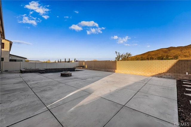 view of patio / terrace featuring a mountain view and a fire pit