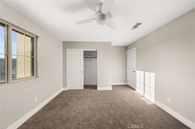 unfurnished bedroom featuring carpet floors, a closet, and ceiling fan