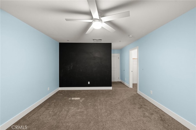 empty room featuring carpet and ceiling fan