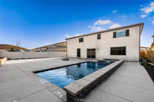 view of pool with a patio area and an in ground hot tub