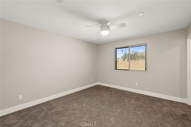 unfurnished room featuring dark colored carpet and ceiling fan