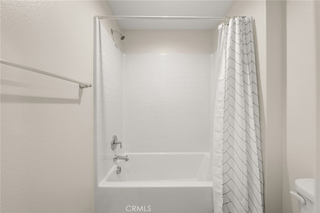 bathroom with toilet and shower / bathtub combination with curtain