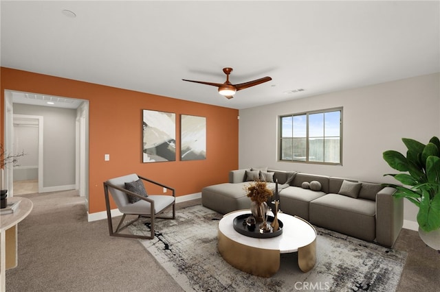 carpeted living room with ceiling fan