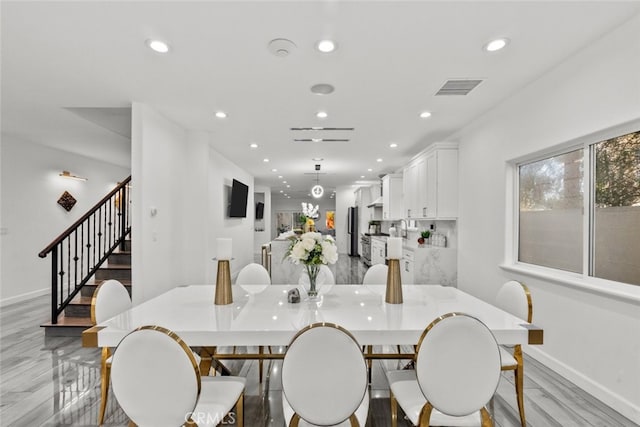 dining area featuring light wood-style floors, visible vents, and recessed lighting