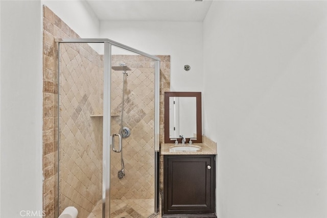 bathroom with a shower stall and vanity