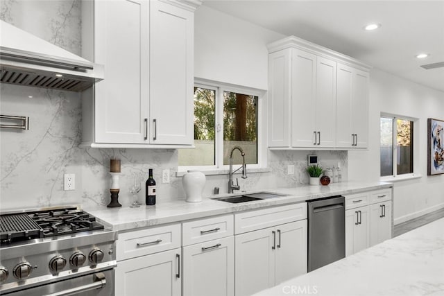 5157 Avenida Oriente, Tarzana, CA 91356 - kitchen featuring a sink, wall chimney range hood, stainless steel appliances, white cabinetry, and decorative backsplash