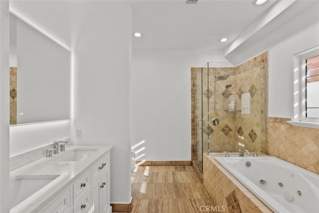 bathroom featuring vanity and plus walk in shower