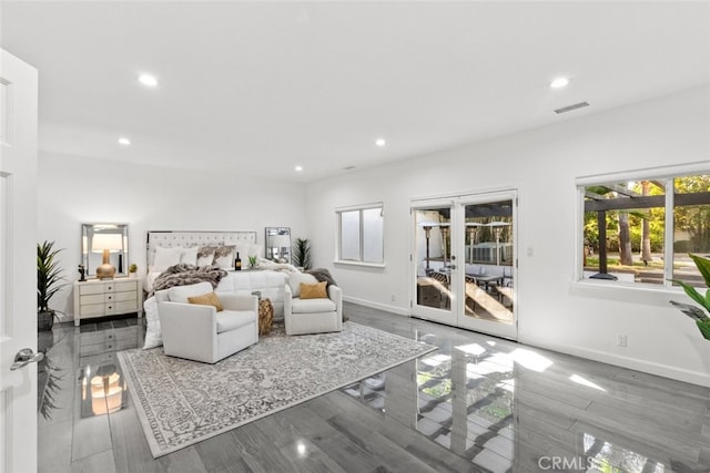 bedroom featuring access to exterior, baseboards, multiple windows, and visible vents