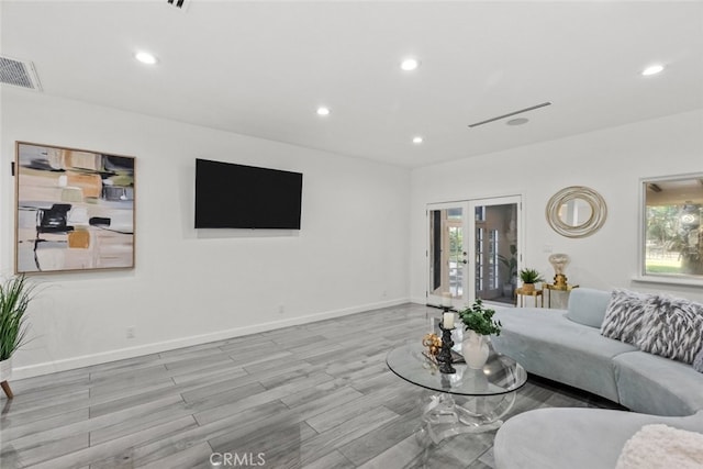 living room featuring french doors, recessed lighting, visible vents, wood finished floors, and baseboards