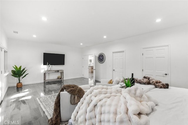 bedroom with recessed lighting, baseboards, and wood finished floors