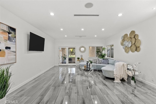 living area with baseboards, french doors, wood finished floors, and recessed lighting