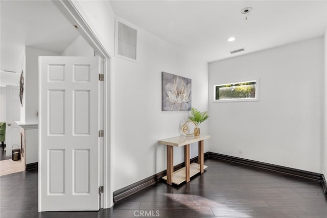 interior space with baseboards, visible vents, dark wood-type flooring, and recessed lighting