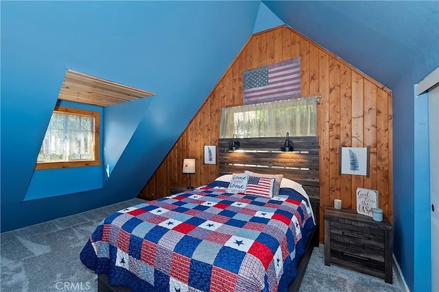 carpeted bedroom featuring vaulted ceiling and wooden walls