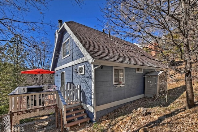 view of side of property featuring a wooden deck