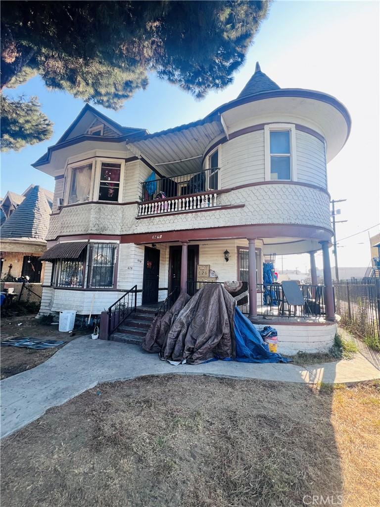 view of front of house featuring covered porch and a balcony