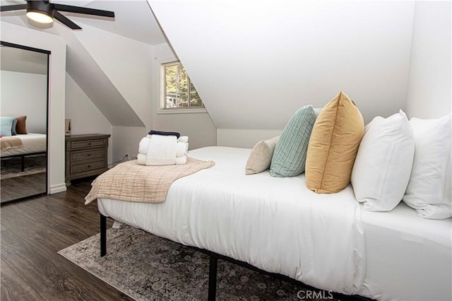 bedroom with dark hardwood / wood-style flooring, ceiling fan, and lofted ceiling